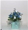 Enchanted Decorating Designs, Tampa — This customized made silk-roses table centerpiece measures approximately 11"H x 9.5"W. This beautiful piece is made up of five coned, navy blue, closed rose buds with a blush of green and five powder white dew-drop, closed rose buds; with baby's breath fillers and greenery. It sits on a 5" square foam cube covered with green tissue and tulle and tied with white and blue ribbon. This centerpiece comes in different colors and is perfect for weddings, anniversaries, birthdays or any special event.