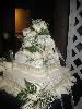 All OURS Catering, Charlotte — A beautiful Wedding Cake using fresh flowers to complete the custom design. All Wedding cakes are baked fresh the day they are ordered and assembled on site.