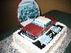 All OURS Catering, Charlotte — More and more Brides and Moms are surprising the Groom with his own personalized cake. Whatever his hobby, his profession, or his life long dream, we can create an edible presentation. This particular cake is a Birthday cake, a combination of fresh cake, edible image paper, hand sculpted chocolate clay and a solid milk chocolate back drop. What a wonderful surprise for any occasion to see his dream car displayed on his cake.