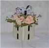 Enchanted Decorating Designs, Tampa — This would surely make your table setting stand out. This beautiful centerpiece measures 11”H x 9.5”W. It consists of six open pink & cream roses, baby’s breath and greenery together with an infusion of a colored bow eloquently placed on a 5” square foam block covered in ivory/cream paper. ½” black satin ribbon runs on each side of the block to give it that classic look. These centerpieces comes in an array of colors so call or email us with your order in quantity and colors. You can check our full selection at www.enchanteddecoratingdesigns.com