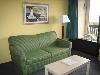 Hampton Inn Cocoa Beach, Cocoa Beach — Some rooms offer a spacious seating area featuring a sleeper sofa, floor lighting and coffee table