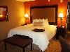 Hampton Inn & Suites Herndon/Reston, Herndon — Each 96 spacious and elegant rooms and suites are designed for comfort while offering an urban, sophisticated setting. Each feature 32'' flat screen HD televisions, complimentary wired and wireless high-speed internet access, complimentary local calls and no surcharge for using a calling card. Enjoy extra touches such as: Cloud Nine bed package, microwave and refrigerator, coffee maker, iron and ironing board. In the bathroom you'll enjoy fluffy towels, granite-top vanity, and a WaterPik showerhead and curved shower rod that allows more light and space in the shower.  All complemented by a contemporary decor with rich espresso furnishings and luxurious fabrics