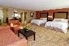 Hampton Inn & Suites Herndon/Reston, Herndon — Need more space?  Hotel features 24 suites. Each feature Cloud Nine Beds either a  King or two queen beds, Sofa bed and living room area, 32'' flat screen HD televisions, complimentary wired and wireless high-speed internet access, complimentary local calls and no surcharge for using a calling card. Enjoy extra touches such as: wet bar, microwave and refrigerator, coffee maker, iron and ironing board. In the bathroom you'll enjoy fluffy towels, granite-top vanity, and a WaterPik showerhead and curved shower rod that allows more light and space in the shower.  All complemented by a contemporary decor with rich espresso furnishings and luxurious fabrics. All of our guests at the Hampton Inn & Suites Herndon/Reston