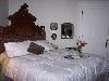 Aavakian - Shadowlawn Bed & Breakfast, Columbus — The Victorian King Suite is a spacious 19 x 20 foot room with 14 foot ceilings. It is decorated in greens and burgundies and includes a King Sized Bed with Victorian Headboard, Private Bath with a Whirlpool Tub and a Walk-in Shower with double shower heads.

     It has a Full-sized Desk with Wi-Fi Internet Access, 23” Television with Cable housed in an 1860s English Victorian Linen Press, Victorian Sofa and Dresser, Apartment-Sized Refrigerator with a selection of water, sodas and juices, Large Antique Over-the-Mantle Mirror, 3-speed Ceiling Fan, and a full sized closet and bedside alarm clock.

     Overlooking the beautiful Victorian Puckett House on the MUW Campus, the Upstairs Master Suite of Shadowlawn is a spacious room furnished with Victorian Antiques and has all the modern conveniences today's traveler needs.