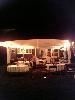 Camelot Special Events & Tents, Inc., Wakefield — This is a 50th Birthaday party uder a 20x30 frame tent.  The tent was attached to the house with a smaller Marquis style tent to allow guests to enter and leave without getting rained on.  As it turned out, it did rain and the party continued without a hitch.

String lighting was used along the perimeter of the tent to create an ambiance that was not overly bright.
