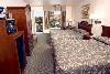 Cortona Inn & Suites Anaheim Resort, Anaheim — Queen rooms are decorated in a comfortable, traditional style. These rooms feature 2 queen beds, work desk, high speed Internet access, microwave, refrigerator, fresh brew coffee-maker, in-room safe, 27” television with premium cable and pay-per-view movies and individual climate control. Sleeps up to 4 adults or 2 adults + 3 children with existing bedding.
