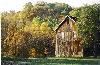 The Conrad Botzum Farmstead, Akron — The East end of the 1898 Bank Barn with beautiful autumn colors on the tree covered hills of Cuyahoga Valley National Park.