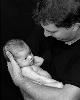 Photocraft By Tom Warriner, Destin — A black and white photo of a beautiful newborn baby and her proud father.