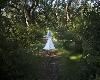 Photocraft By Tom Warriner, Destin — The bride is strolling through the grounds of Eden Gardens State Park in South Walton County, Florida. The park is a wonderful location for outdoor weddings.