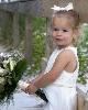 Photocraft By Tom Warriner, Destin — The flower girl is holding the bride's bouquet before the wedding on Okaloosa Island in Fort Walton Beach, Florida.
