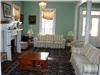 Entertainment area, Ashley Rose Victorian Inn, Cape May — livingroom opens to dining area.  Double doors lead to wrap around porch
