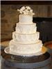 Elizabethan Delights, Charlotte — Roses and grapes adorn this wedding cake.  Elaborately piped detail in a Victorian style.