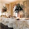 MADE FROM SCRATCH, Columbus — Eligant white with large floral vases.
