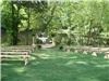 Alda's Magnolia Hill, Little Rock — Hand hewn wooden cypress benches are right at the waters edge as guests view the wedding ceremony on the stone altar.