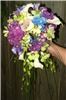 Snapdragon Studio, Vancouver — For the bride with a little attitude! This bright bouquet combines the hand-tied style with some trailing elements, for a very modern feel. Flowers include hydrangea, calla lilies, orchids, bear grass, and fern curls.