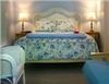 The Brewster Inn, Dexter — The Hideaway guestroom is a spacious and private first floor retreat which is decorated in calming shades of blue and adorned with accents of Blue Willow china and items from the sea. This room features a queen size bed, sitting area with double futon, television and wicker chairs.  

The bright and cheerful bath has a romantic oval whirlpool tub/shower. Perfect for relaxing after a long day of sightseeing and shopping. 

This room has generous closet space which makes it ideal for longer stays at the Brewster