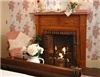 The Brewster Inn, Dexter — The Brewster Suite (originally the master bedroom) is a bright and cheerful room which feels instantly welcoming upon arrival. It features a romantic gas log antique fireplace which you can enjoy from both the queen size sleigh bed and sitting area.  

The main area is spacious and decorated in pretty floral prints. A large dresser provides plenty of storage space. The sitting area has two elegant side chairs and wicker coffee table. 

A large private (retro 40's) pink tile bath with tub/shower adds luxury and charm to this very special suite.