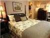 The Brewster Inn, Dexter — The Beckford Room  -  Rich shades of green and traditional english style furnushings set the mood for the newly decorated Beckford guestroom. (formerly the Rose Room) 

Looking out over the gardens makes for cheerful mornings. This mid-size room is furnished with a comfortable queen size bed. 

A large television stands in one corner and can be enjoyed from the comfort of the bed or the lady's side chair. A 4 drawer dresser provides ample storage. 

The spacious private bath features a tub with shower.