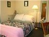 The Brewster Inn, Dexter — The Fern Room  -  Warm and cheerful yet functional......
 Located on the main level, the Fern Room is wheelchair accessible and includes an ADA approved bathroom. (shown below left) 

A full size white iron bed and a matching twin size bed (both in view of the television) accommodate traveling companions, while a small desk provides ample working space for the business traveler. For your convenience, the Inn has complimentary wireless internet access throughout. Bring your laptop!