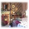 MoonStruck Manor B& B and Gift Shop, Gifts & Whimsey Shop at MoonStruck B&B, Syracuse — The "Rose Room" is everything you'd want in a bed and breakfast room. Decorated in a light-hearted Victorian style, complete with Queen size four-poster bed, TV (Hidden in the armoire, of course!) and a fireplace with its own romantic trompe l’oeil fire!