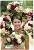 Enchanted Florist - Everett, Everett — One of my favorite color combinations.  Pink, mauve, burgundy, and creamy white.  The bridesmaids bouquets made a romantic arbor surrounding the bride.