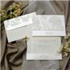 Calla Graphics, Lodi — Rich exclusive silk brocade complements our exclusive champagne stardust, with beautifully embossed monogram strip horizontal holder, invitation opens to reveal ivory linen layered on champagne stardust, with graduated oversized champagne stardust reception card and ivory linen respond card all printed in our incomparable champagne ink, with ivory linen straight flap envelope laminated silk brocade fabric flap and printed champagne stardust address strip.