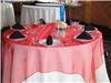 LinenTablecloth - Dallas, Dallas — Red Organza Overlay with 120" white round and black napkins.