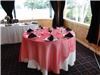 LinenTablecloth - Dallas, Dallas — Red Organza Overlay with 120" white round and black napkins.