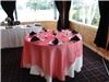 LinenTablecloth - Sacramento, Sacramento — Red Organza Overlay with 120" white round and black napkins.