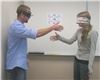 Education by Entertainment, Daytona Beach — Shaking hands.  Chris Kelley (wearing 180 degree inversion prisms) and Laura Whitlock (blindfolded) attempt to shake hands in one of the EduTainment activities at North Carolina State University in October 2008.