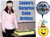 Education by Entertainment, Daytona Beach — A surprise birthday cake being delivered for Luana Matos from Brazil at a corporate meeting in North Carolina.  The cake was decorated with a flag from Brazil.