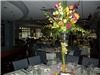 Annie's Orchids, Philadelphia — Cymbidium orchids in 30" high pilsner vase with top arrangement of orchids and roses.