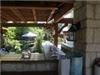 Entire Facility, Stone Creek Terrace, Frisco — Under patio cover, bar area on other side of creek