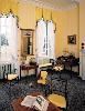 Homewood House Museum, Baltimore — Back Parlor:
Although used by the Carrolls in much the same way a family room is used today, the Back Parlor is quite formal in appearance. Microscopic paint analysis conducted during the restoration of the house in the 1980s revealed evidence of adhesive on the walls, documenting the use of wallpaper. The black painted and gilt armchair, on loan from the collection of the Maryland Historical Society, is the only piece of furniture that has survived with a history of original use at Homewood.