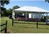 EMS Party Rentals LLC, Bastrop — Company gathering in Bastrop, Texas.  Full Set-Up.  Tent with skirted legs, tables, chairs, linens, dinner and barware. (beer mugs, blue enamelware plates, wine glasses, water glasses, flatware)