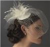 Fairytale Bridal Tiara, Miami — Modern meets vintage, with this elegant ivory Russian Tulle Face Cage Bridal Hat. This accessory is the perfect touch for an old fashion 20's wedding style ceremony. This piece has a gorgeous flower accenting the top of the hat, with scattered Swarovski Crystals and sprays of feathers.