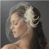 Fairytale Bridal Tiara, Miami — A chic alternative to a long veil, this stunning birdcage veil fastens to your hair with a 3" comb. The comb ornament is a charming double cloth flower with faux pearl, rhinestone, and seed bead accents