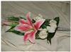 WeddingBouquets - Rapid City, Rapid City — This silk attendant's bouquet is designed with: a Natural Touch rhubrum lily, Natural Touch rose buds, wispy grass, greenery, and ribbon.