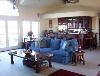 Mediterranean Mansion, Rancho Valle Milagro, Tucson — The great room like the living room is flanked by French doors, the front leading out to a balcony with the rear doors leading out to the patio. The great room also features a media center and full service bar.
