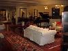 Mediterranean Mansion, Rancho Valle Milagro, Tucson — The large living room has comfortable furnishings and a baby grand player piano.