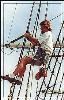 Elissa, Texas Seaport Museum, Galveston — Volunteer Bruce Kuehn applies pine tar to ELISSA’s rigging while suspended in a bosun’s chair