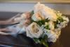 Beautiful Blooms by Larry, Carlsbad — 2 bridesmaids bouquets in ivory and champagne lying down
on table prior to ceremony
