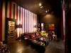 Palazzo Lavaca, Austin — Downstairs screening room and lounge area looking toward the back door.