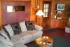 Cathedral Rock Lodge and Retreat Center, Sedona — Homestead House Living Room with Fireplace and Picture Window of Cathedral Rock