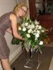 From Menus to Venues, Saint John — Our lead planner rearranging a big, beautiful flower arrangement at a wedding reception.