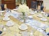 From Menus to Venues, Saint John — Beautiful table done with a gold table cloth, wide gold table runner and a narrow table runner with a French provincial print! The tables were topped with simple cream colored floral cetnerpeices.