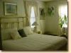 The Country Place Retreat & Conference Center, White Haven — The Eagle room is luxuriously adorned in beige eyelet with a king size brass bed and private bath.